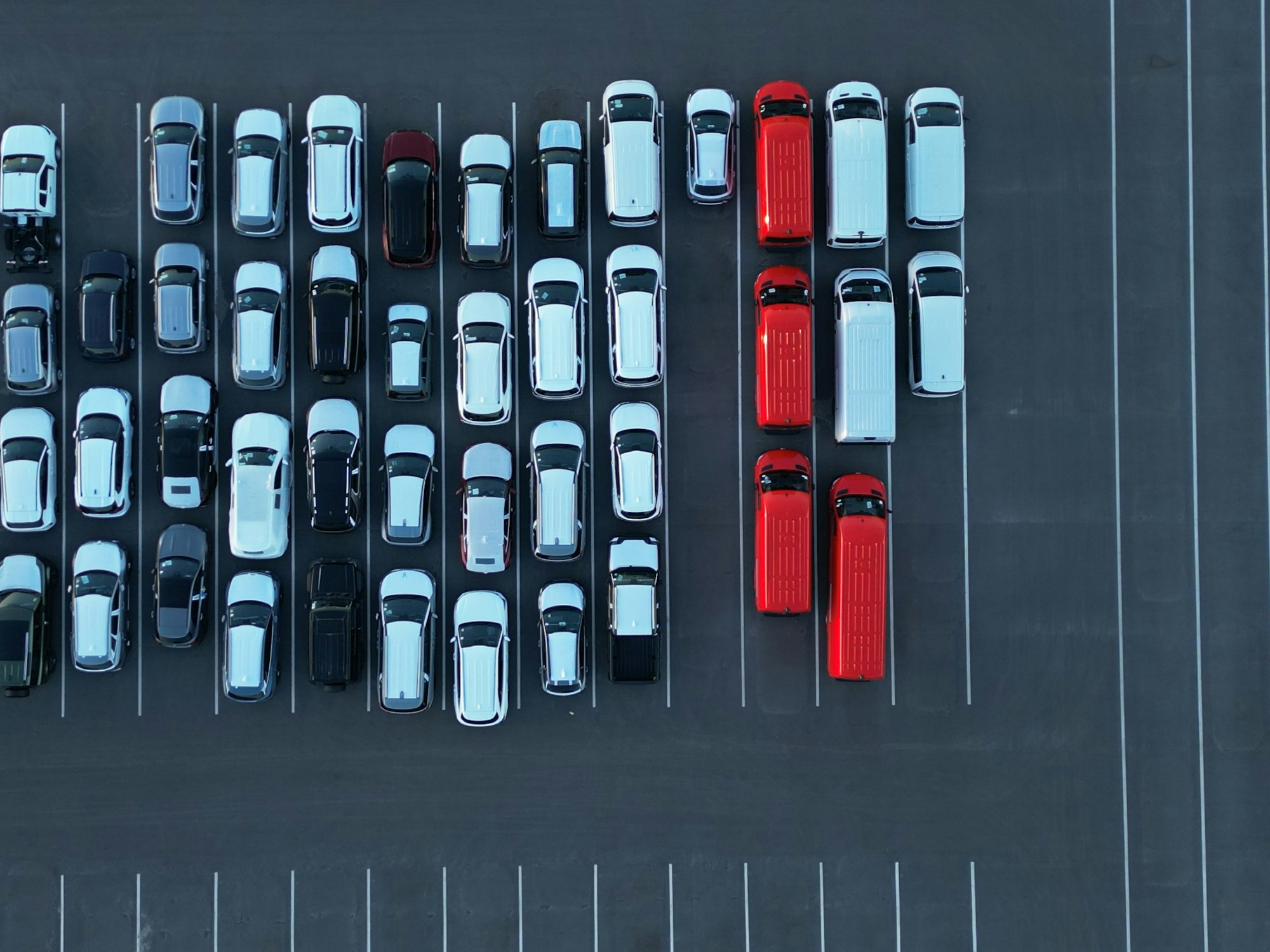 Aerial view of a parking lot with many cars