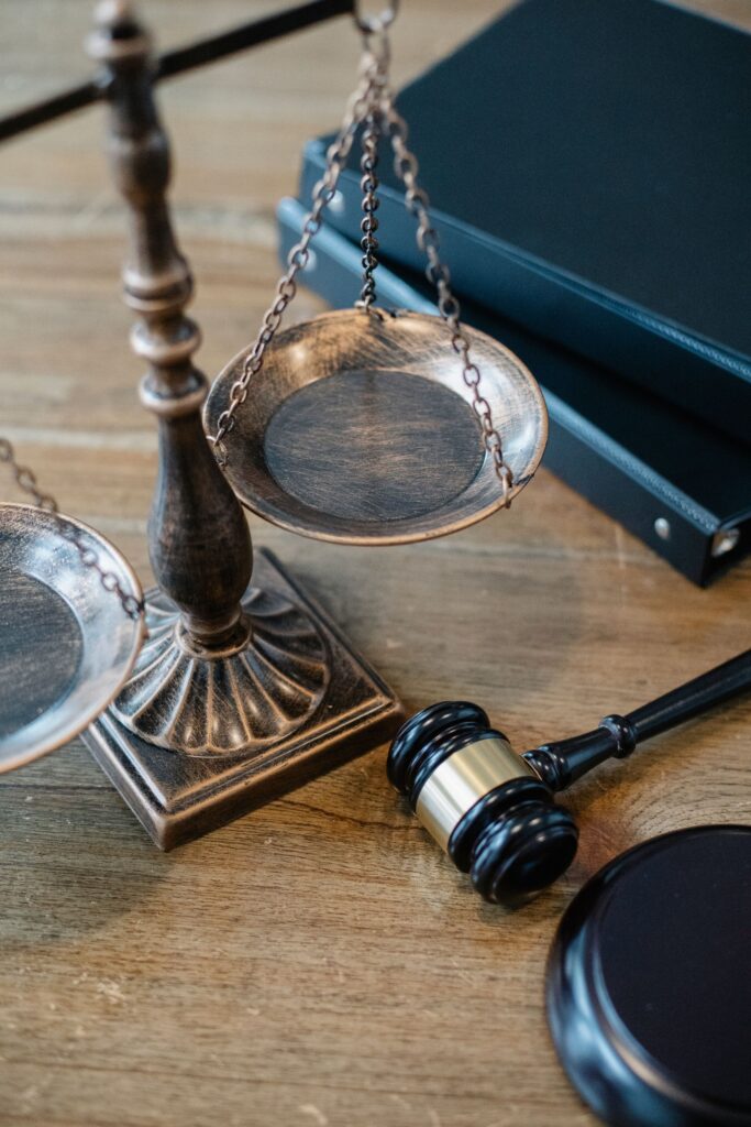 Gavel and scales of justice on a desk with law books